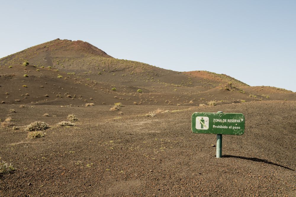 Caution sign near hill slope