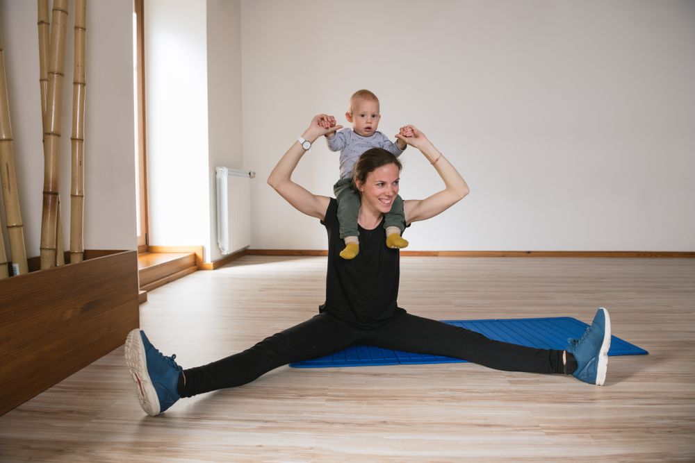Mother exercising with baby in gym
