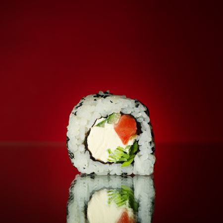 Delicious sushi roll on mirror background, close up. Japanese food