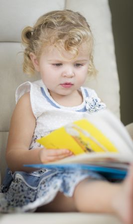 Cute Little Girl Reading Her Book