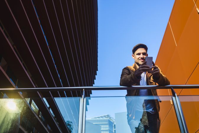 Man using mobile phone in modern building