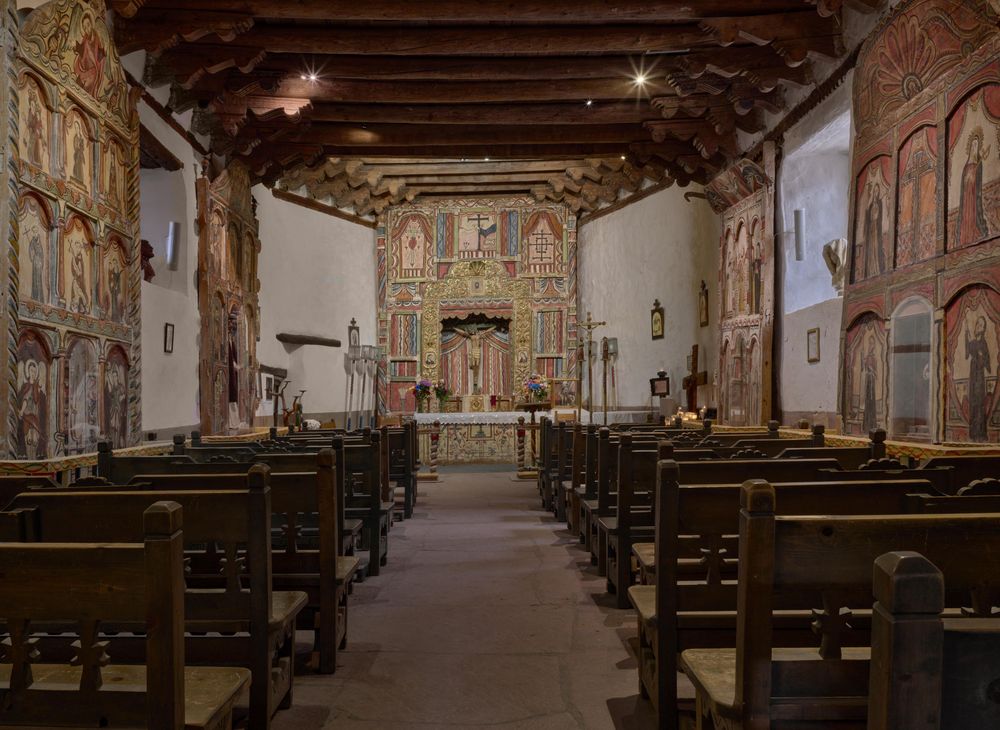 Ornate mission style catholic alter centered around the crucifix