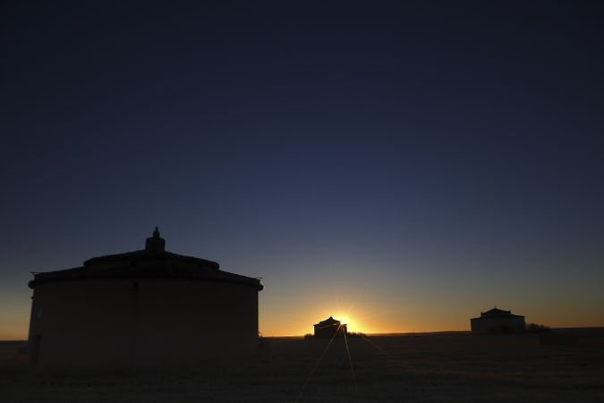 Aged house in rural countryside under starry sky