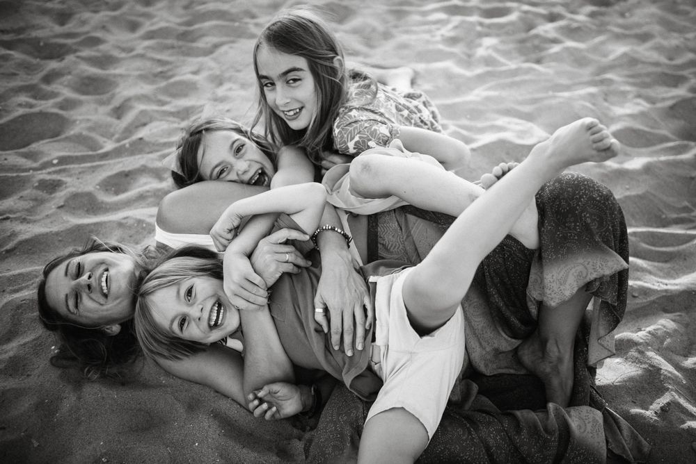 Playing woman with kids on beach