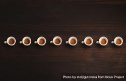Row of espresso shots on a wooden table 5qr7E4