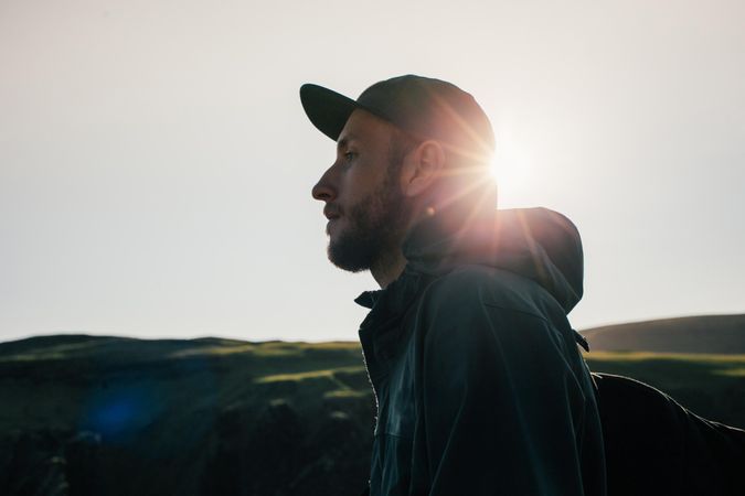 Profile of young man by rugged terrain