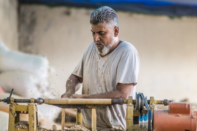 Man using woodworking machine at workplace