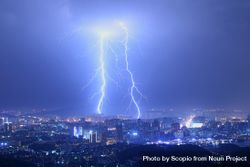 Lightning striking a city during night time 4OJLJ5