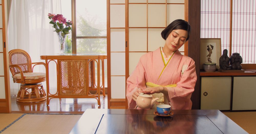 Young Japanese Female Enjoying Time Alone and Drinking Tea at Home.