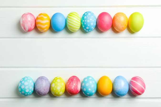 Decorative Easter eggs on wooden background, space for text. Top view