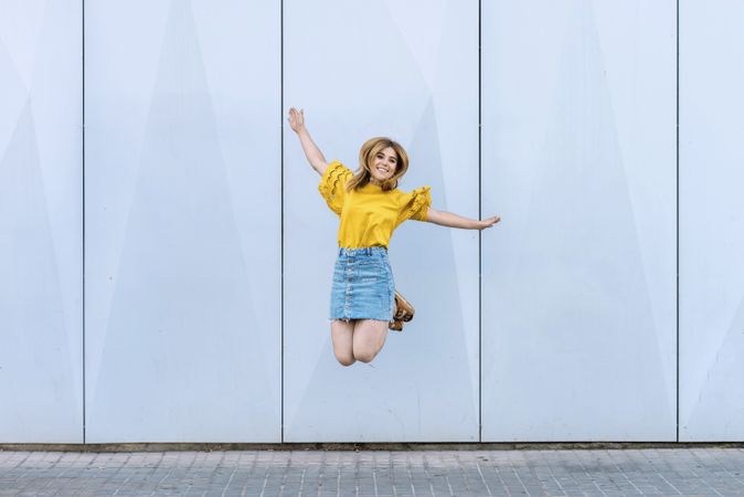 Young cheerful woman jumping