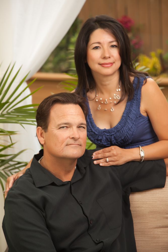Portrait of Loving Couple In Front Of Fern