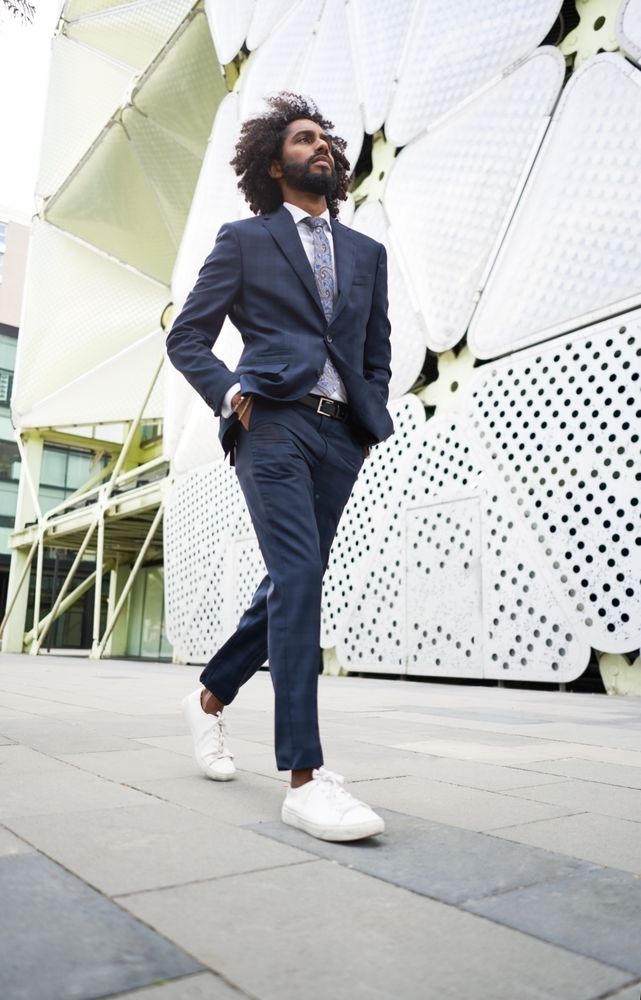 Male office worker walking near modern building