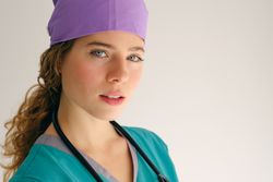 Female doctor in workwear in studio