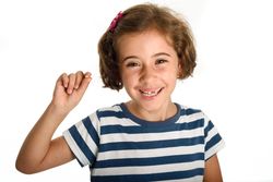 Smiling little girl showing her first lost tooth
