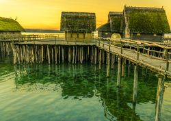 Fishing huts suspended on pillars at sunset