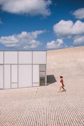 Woman next to contemporary building