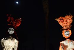 Two tall papier mache skeletons at Day of the Dead event