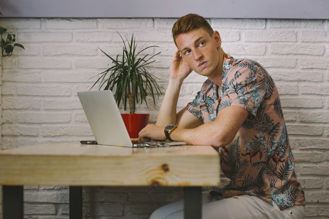Man working on browsing laptop