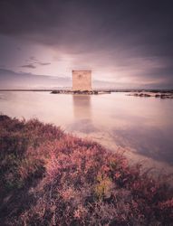 Wonderful watchtower in calm lake on cloudy day
