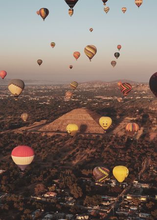 Colorful hot air balloons in flight over pyramids in Teotihuacan Valley, vertical