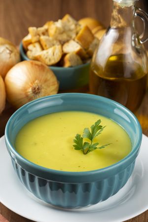Bowl with onion soup and croutons on the table.