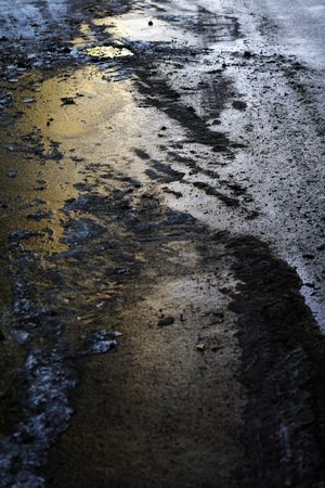 Snowy slush on concrete road in dusk