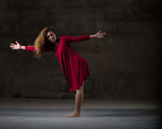 Young woman dancing in darkness