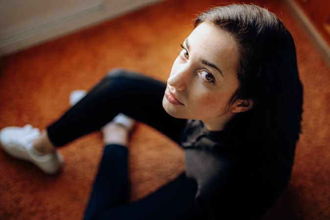 young woman looking straight ahead with serious attitude