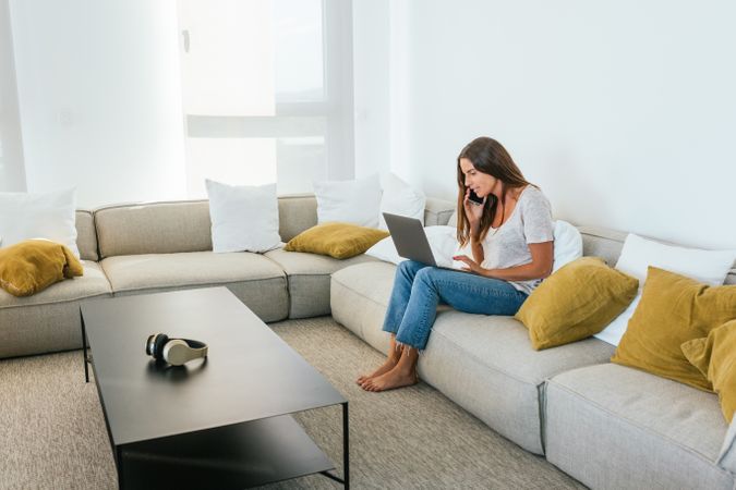 Woman browsing laptop on couch