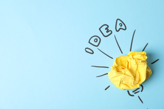 Drawn light bulb and paper ball on blue background. Good idea concept