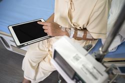 Asian female patient recovering from illness in hospital room, health care concept.