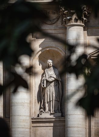Ancient sculpture in one of the churches of Paris. Antique art.