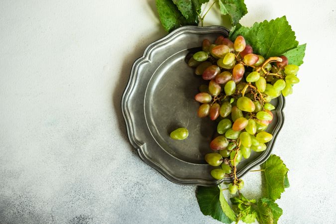 Top view of fresh grapes on grey plate
