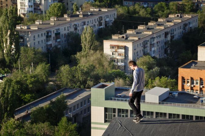 Man walking towards edge of roof