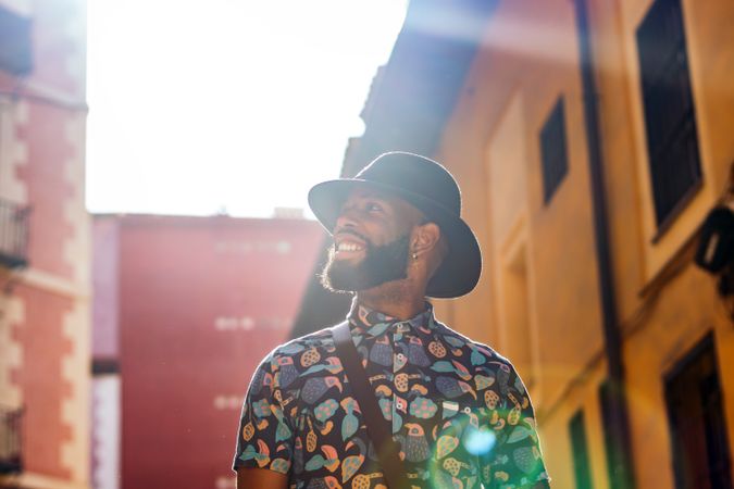 Stylish Black man walking on the city street