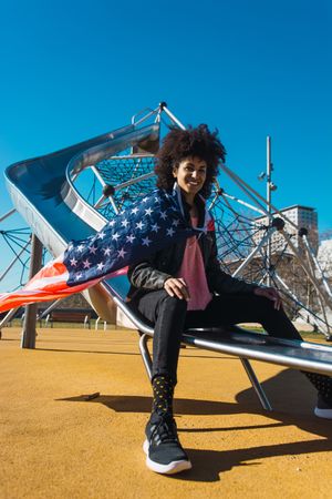 Black woman with afro hair and an american flag.