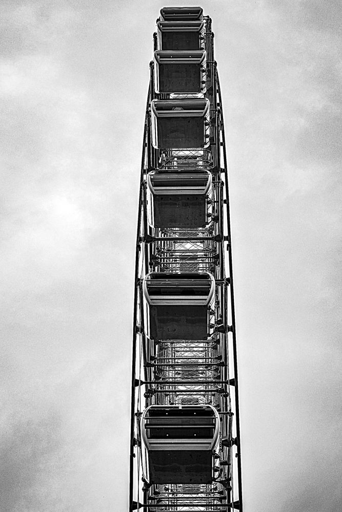 Side view of Ferris wheel in grayscale
