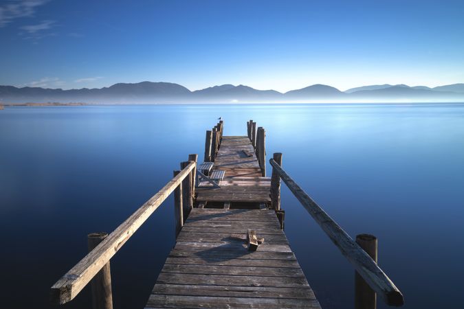 Wooden pier at sunrise, Lake Massaciuccoli, Tuscany, Italy
