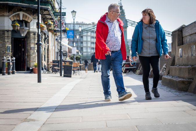 Older man and woman walking on Thames path