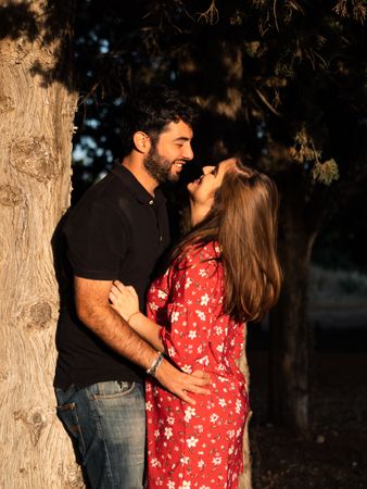 Young happy couple embracing in beautiful garden