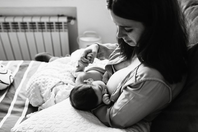 Mom breastfeeding at home