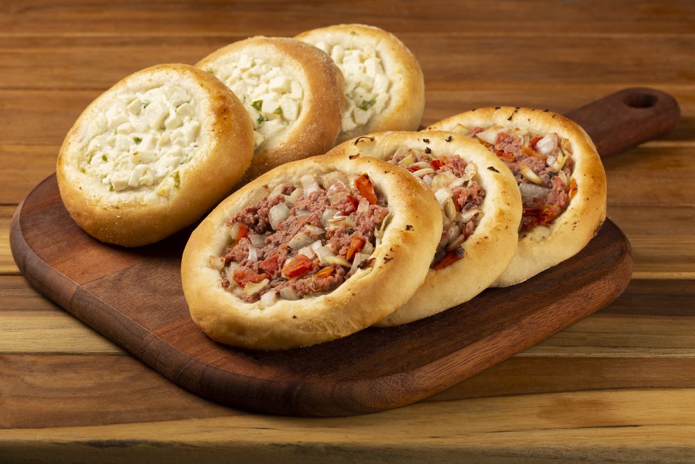 Arabic meat and cheese sfiha on the table.