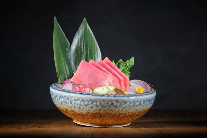 Ceramic plate with raw fish and vegetables