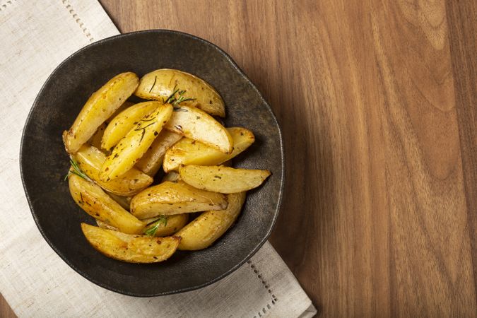 Roasted potatoes with rosemary on the plate.