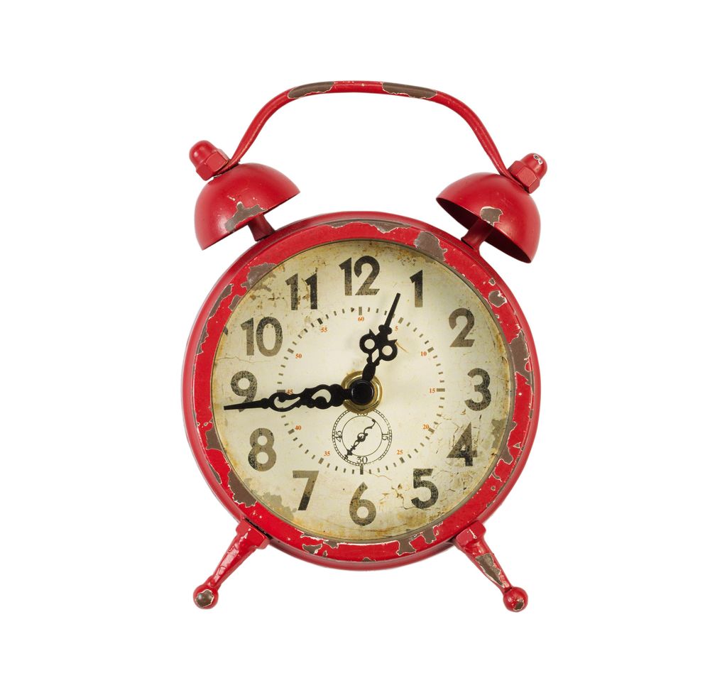 Old alarm clock on blank background
