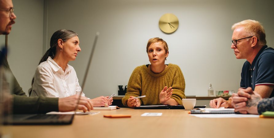 Businesswoman discussing new plan in meeting with colleagues