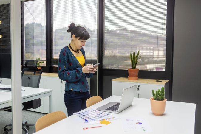 Businesswoman using smartphone at office