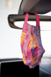 Close up of colorful PPE mask in car