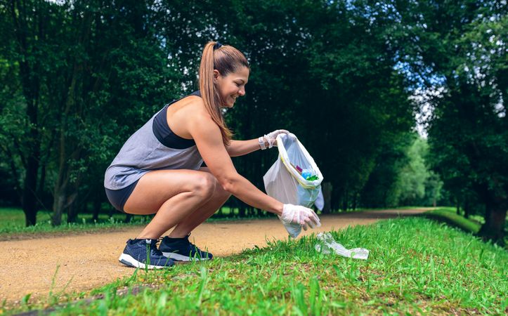 Woman with garbage bag doing plogging